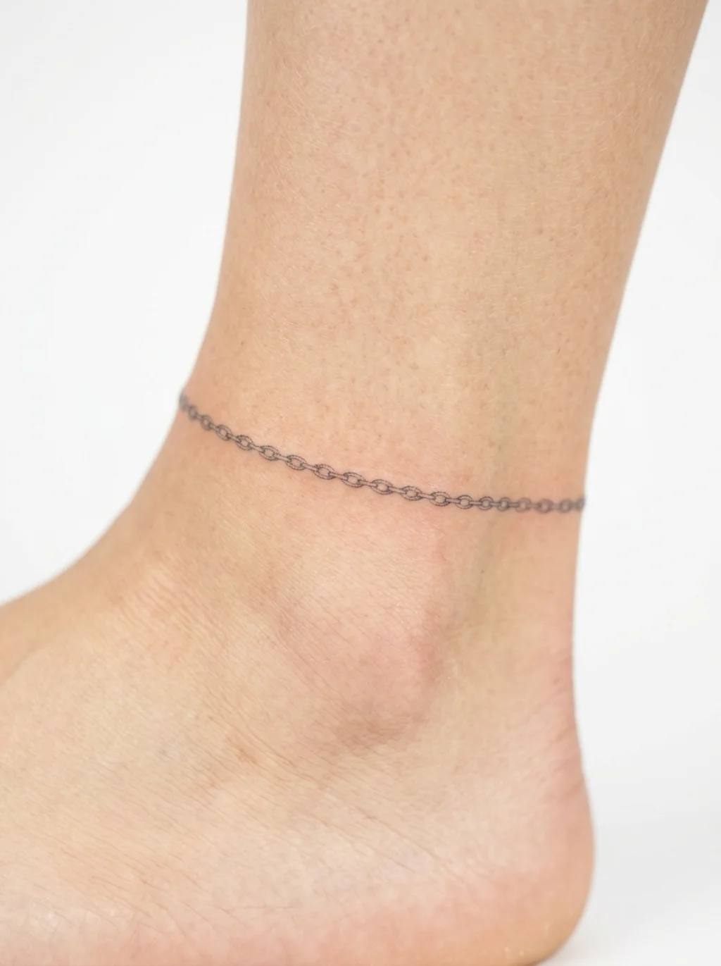 Fine Line Anklet Tattoos That Circle the Ankle With Impossible Delicacy